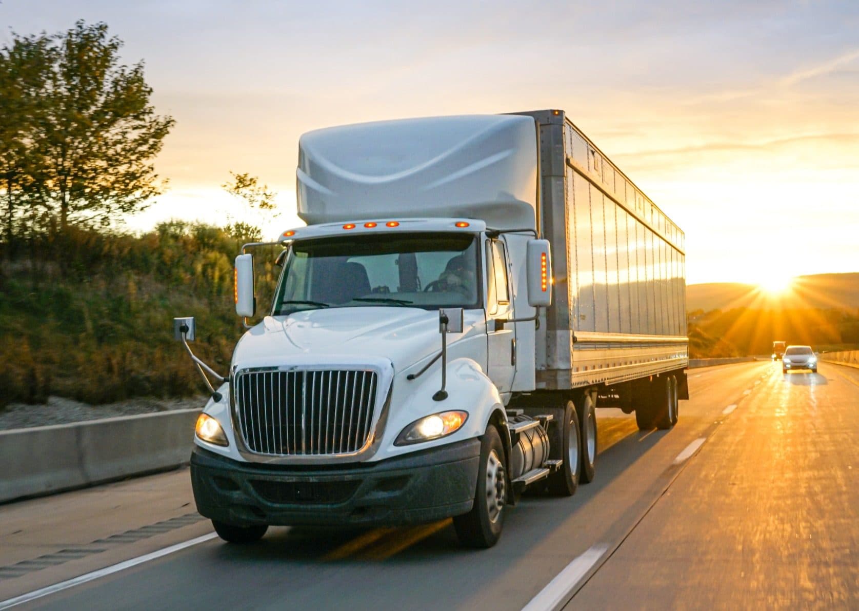 Tractor-trailer on the highway at sunset