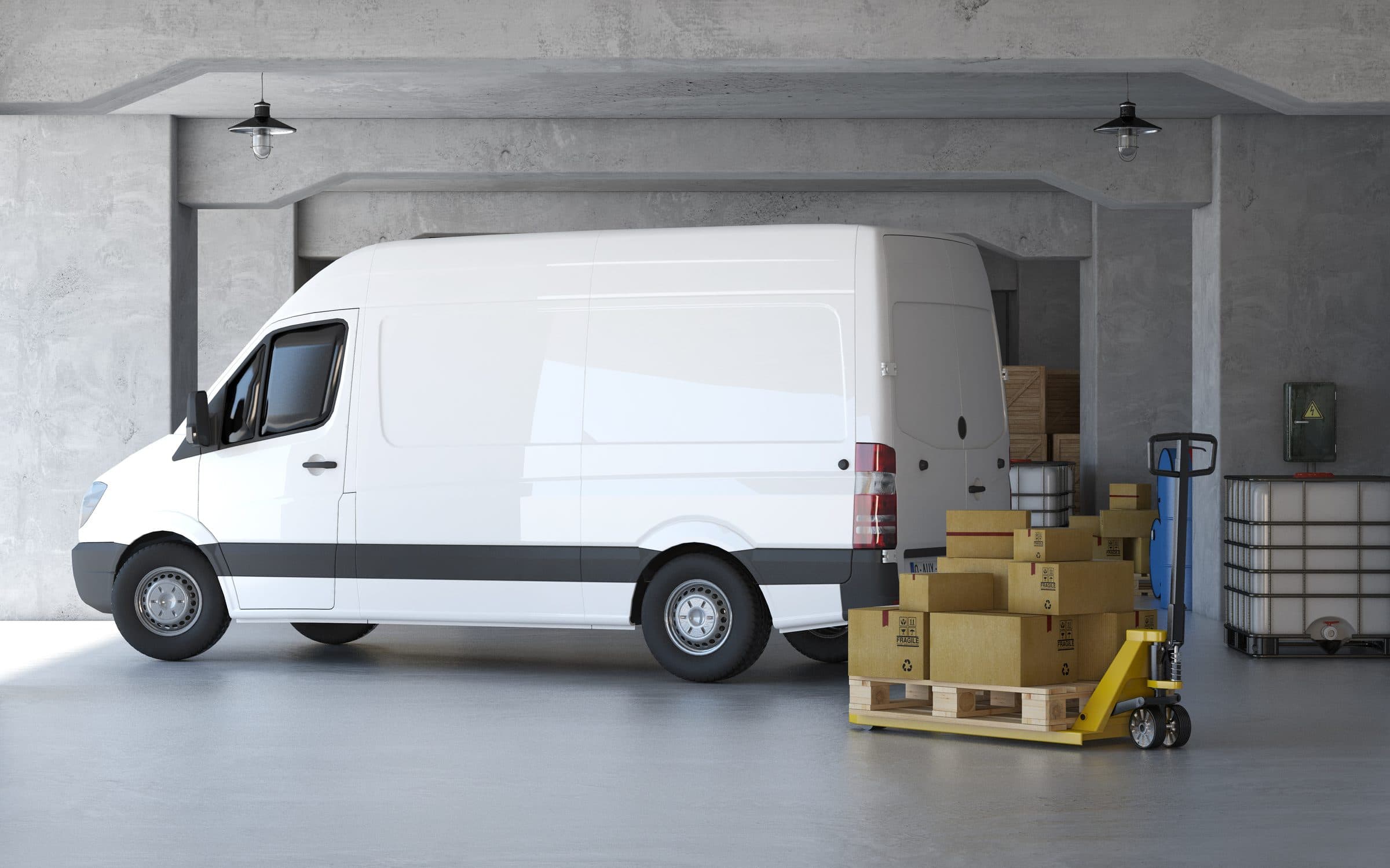 Delivery van beside palletized boxes in a warehouse